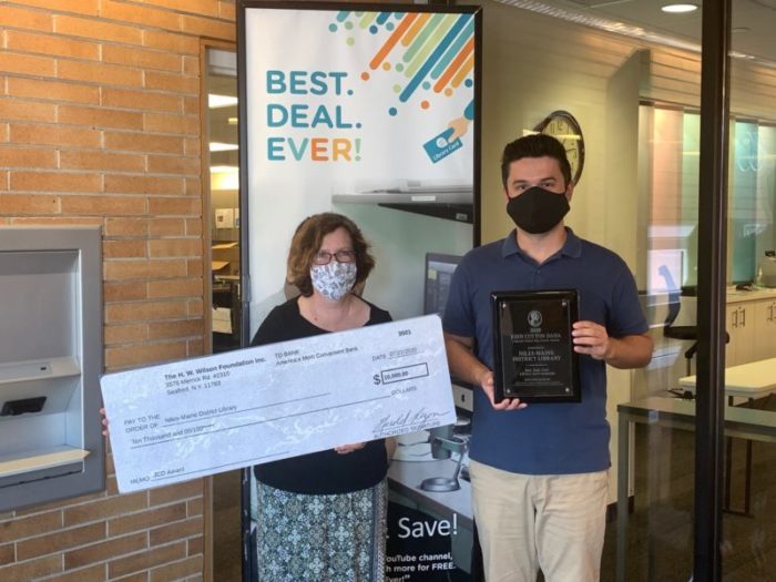 Posing with check and winner
