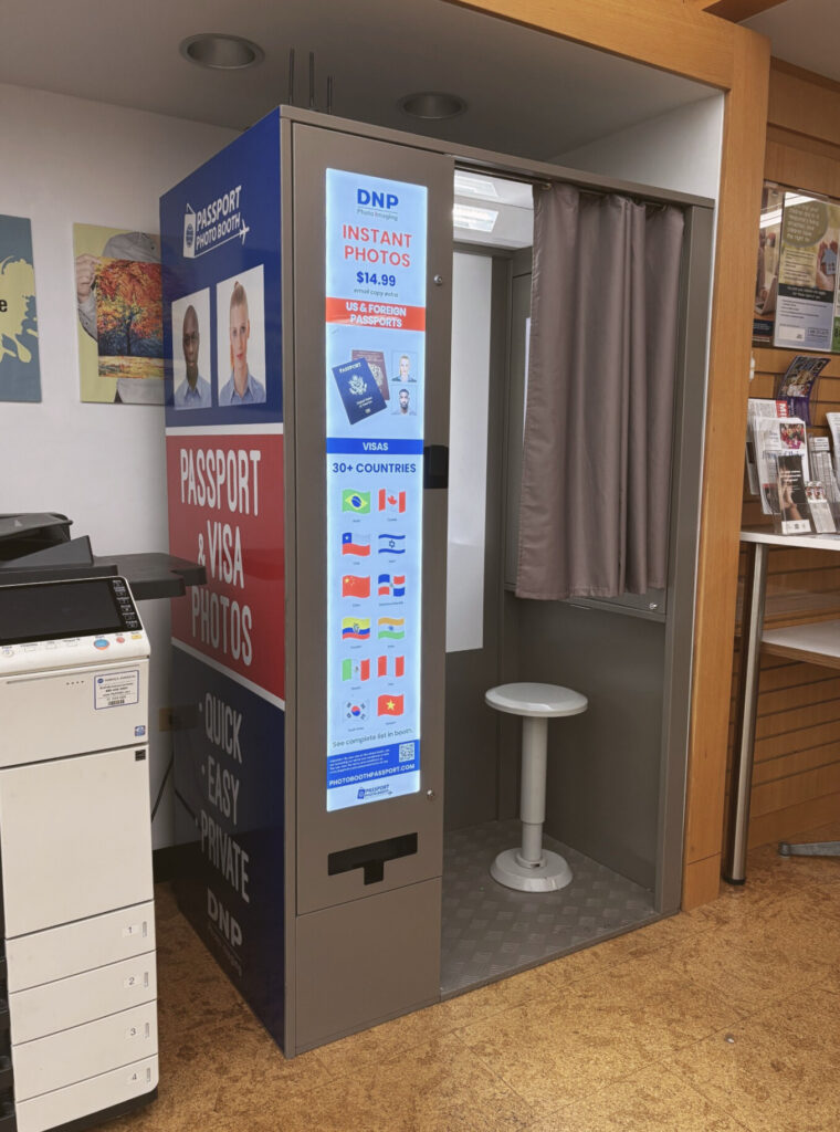 A photo booth in a public library, meant for taking self-service passport photos.
