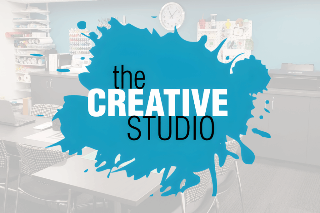 Library maker space with crafting equipment. Paint splotch with text: the Creative Studio.